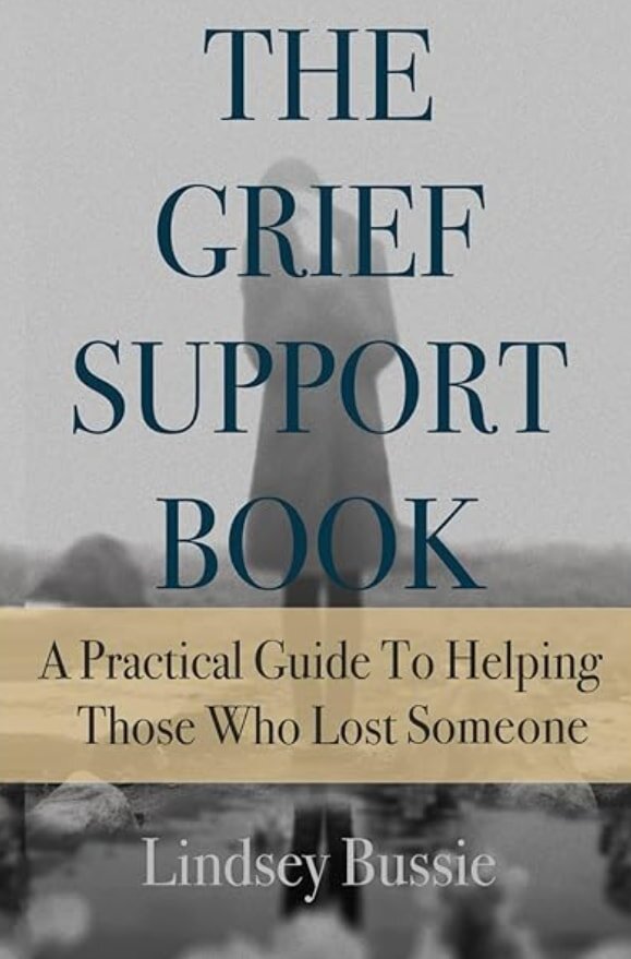 Cover of "The Grief Support Book" by Lindsey Bussie. A blurred figure stands against a gray background, conveying a somber, reflective mood.