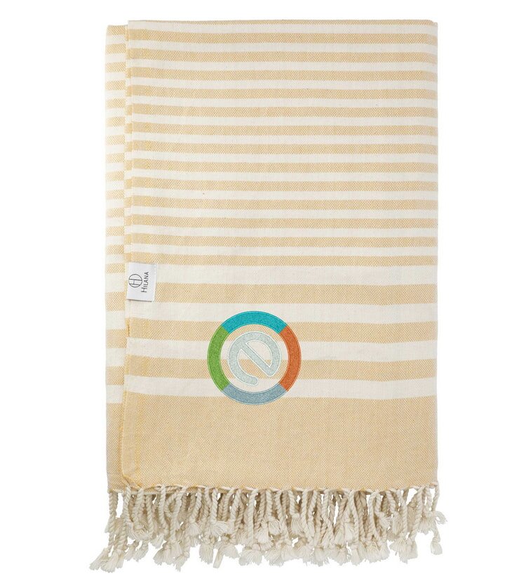 Yellow and white striped towel with fringe and logo