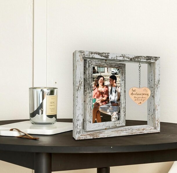 A wooden frame displays a photo of a smiling couple, capturing a moment of joy and togetherness.