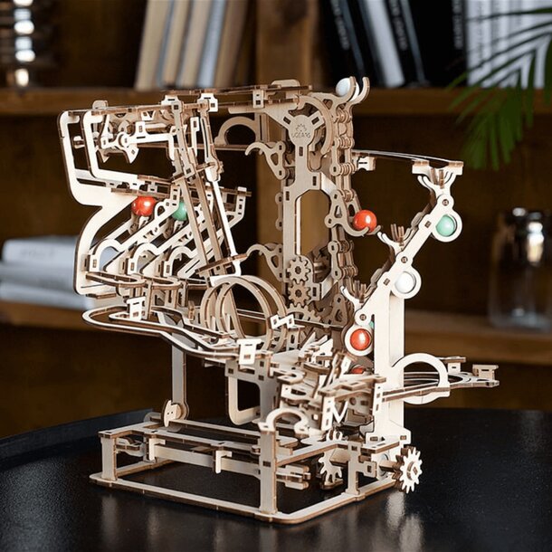 A detailed wooden model of a machine featuring intricate gears and levers, showcasing mechanical design and craftsmanship.