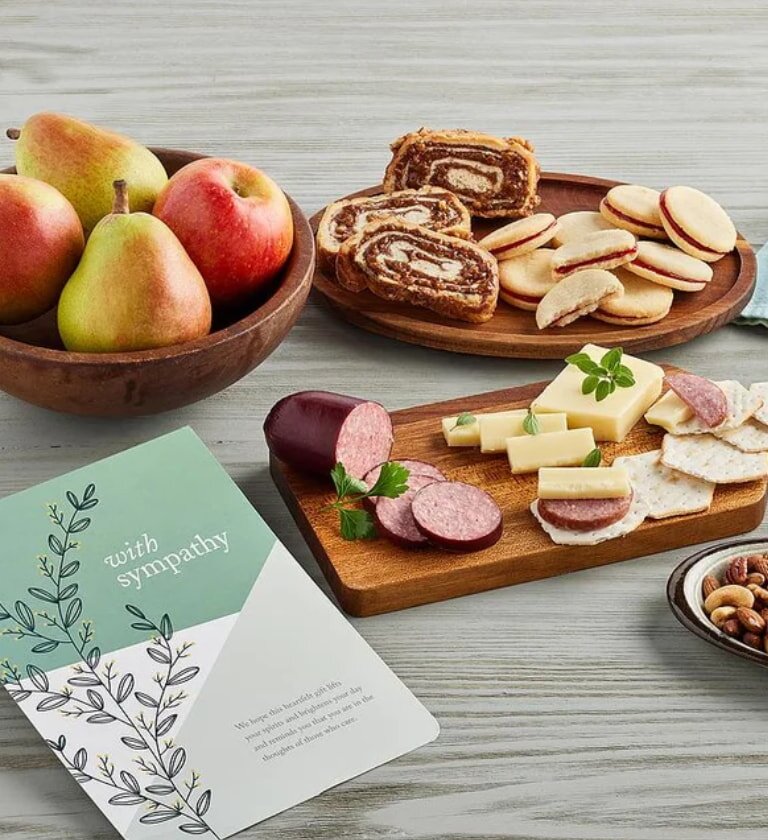 A table set with a variety of food items and a greeting card placed among them.