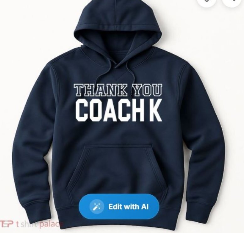 Navy blue hoodie with bold white text saying "Thank You Coach K." Simple design conveys appreciation and respect, with a sporty tone.