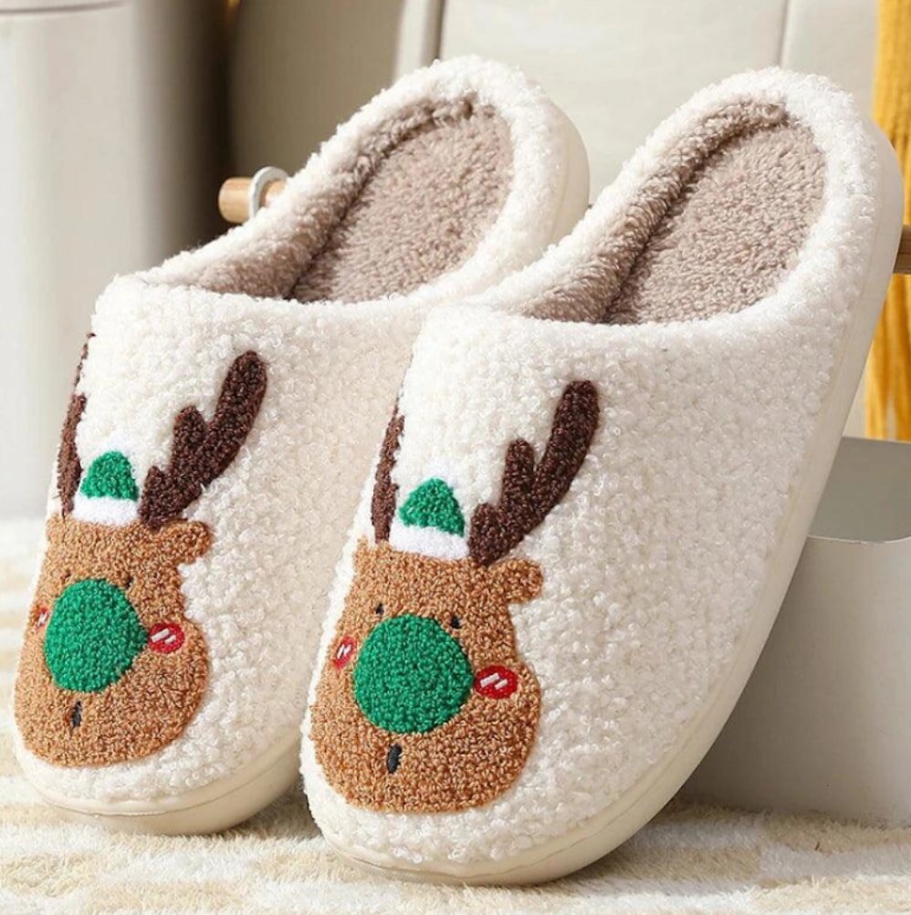 Slippers adorned with a cheerful reindeer face, perfect for holiday comfort.