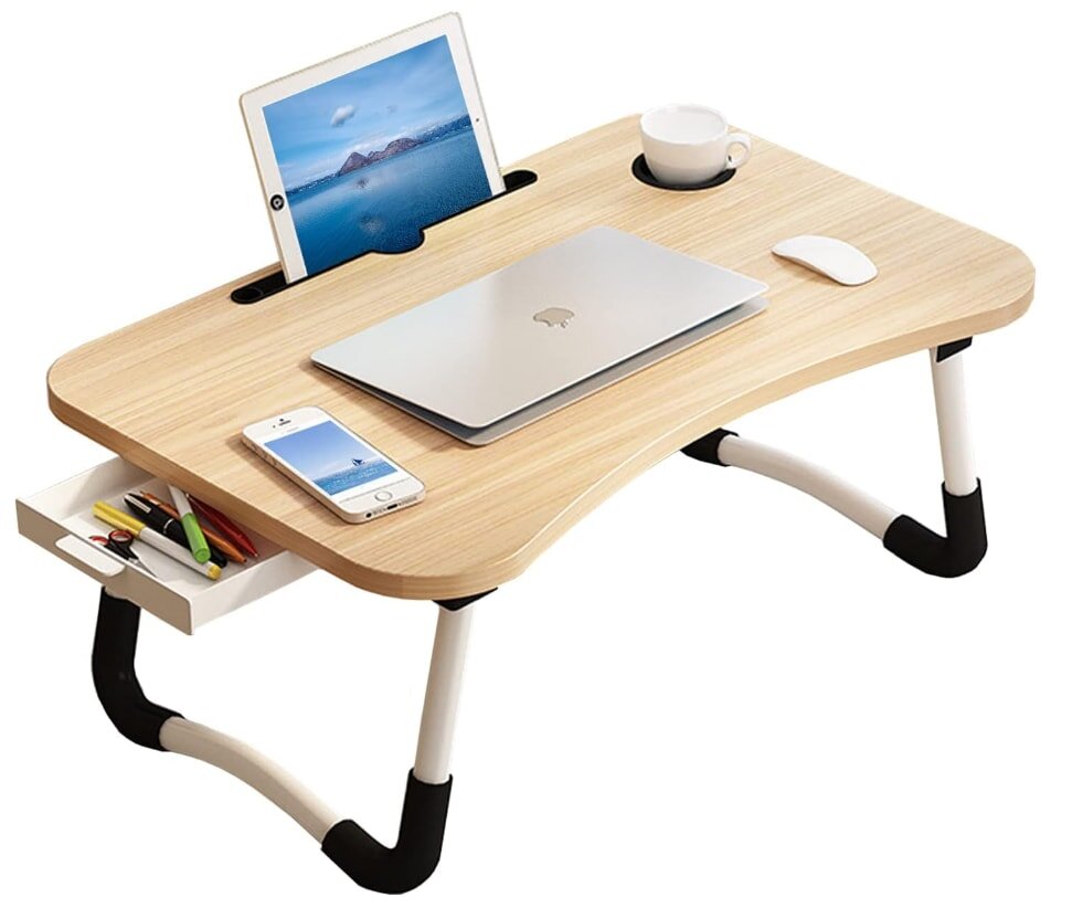 A laptop on a desk beside a tablet and a steaming cup of coffee, creating a cozy workspace atmosphere.