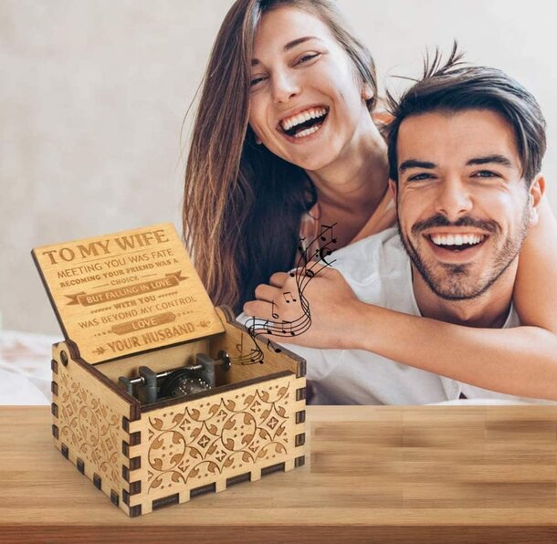 Personalized wooden music box with intricate carvings and a custom nameplate, evoking nostalgia and charm.