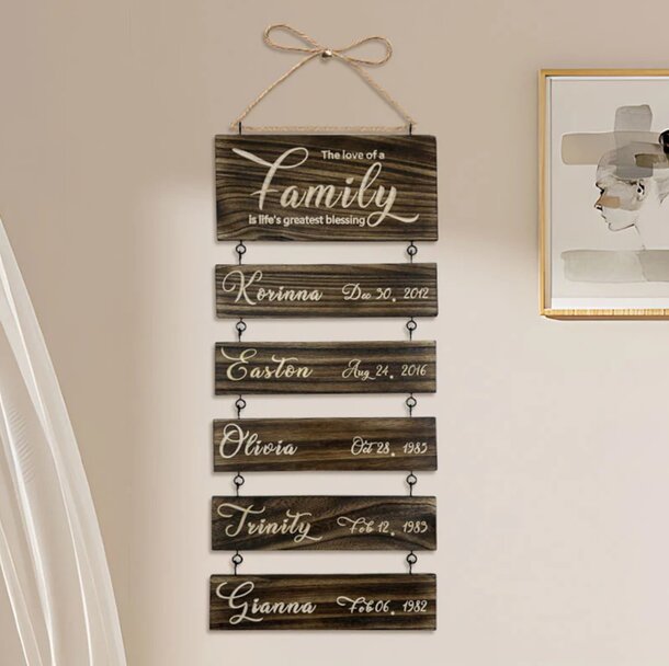 A wooden sign displaying the word "family" in a rustic font, hanging from a decorative hook.
