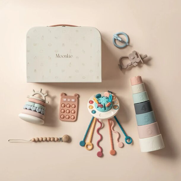 A colorful baby toy box filled with various toys, including plush animals and building blocks, inviting playtime exploration.