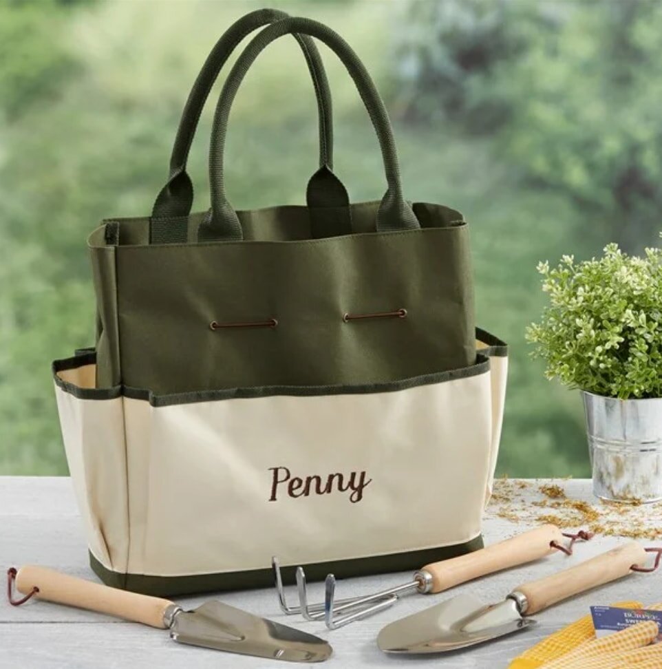 A personalized garden tool set featuring engraved handles and essential gardening tools for plant care and maintenance.