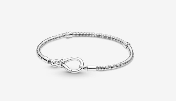 A silver bracelet featuring a heart charm, elegantly designed for a stylish accessory.