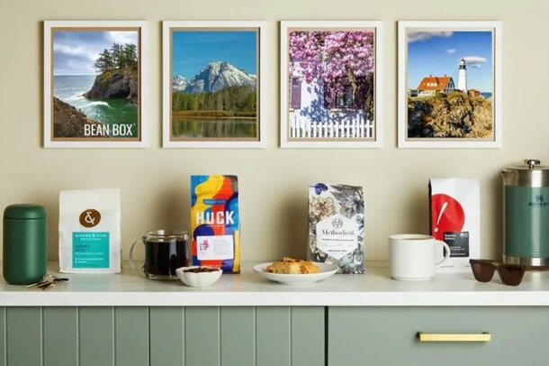Four framed pictures of various locations displayed on a kitchen counter, adding a personal touch to the space.