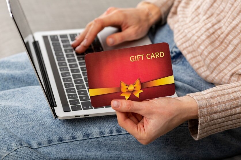 Gift card displayed on a laptop keyboard, suggesting online shopping or digital gifting.