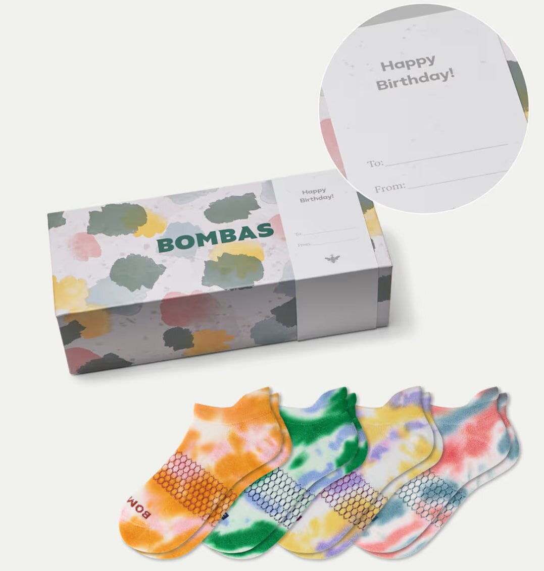 Colorful tie-dye Bombsa socks featuring vibrant swirls of blue, pink, and yellow on a soft fabric background.