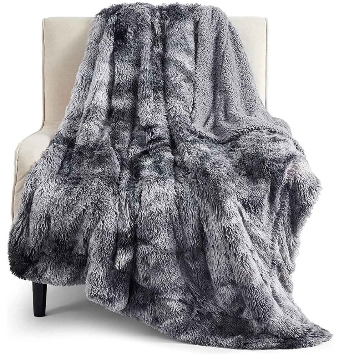 A large blanket featuring a blend of grey and black fur, providing a cozy and luxurious appearance.