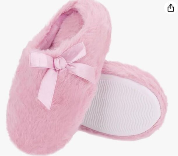 A pair of pink slippers featuring a decorative bow on the sole, designed for comfort and style.