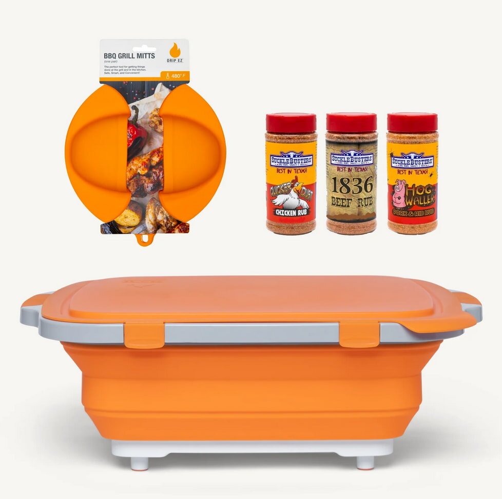 An orange spice container sits on a wooden spice rack filled with various jars of spices. 