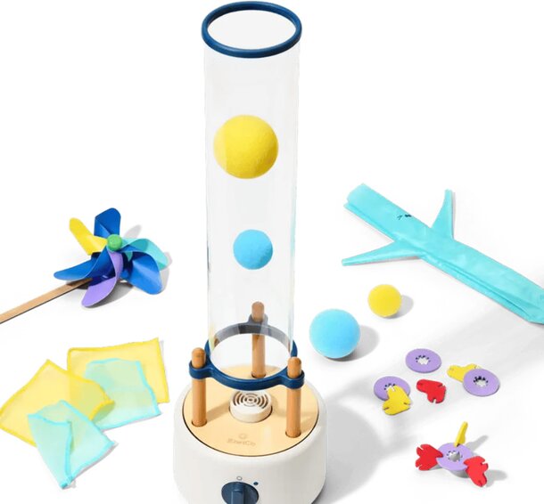 A collection of toys including a wind-up toy, a colorful ball, and various other playful items arranged together.