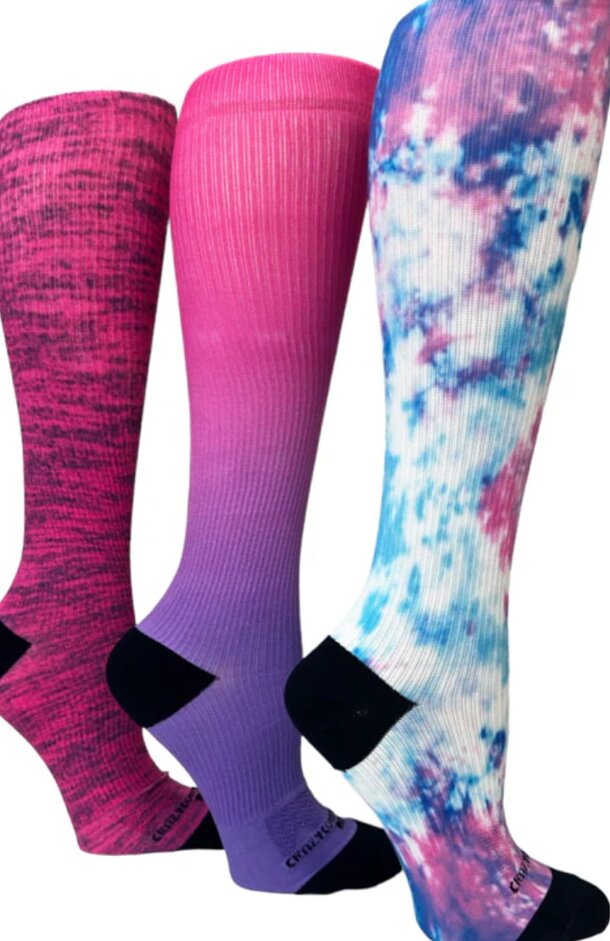 Three pairs of women's tie-dye socks in vibrant colors, showcasing unique patterns and styles.