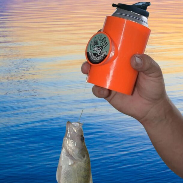 A person holds a fish in one hand and a can of beer in the other, smiling at the camera.