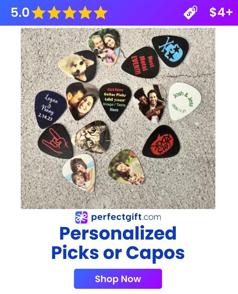 Ten custom guitar picks with various images and text designs are arranged on a textured gray surface.