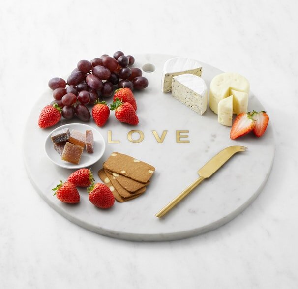 A playful dog poses for a photo during a pet photo session in a sunny outdoor setting.