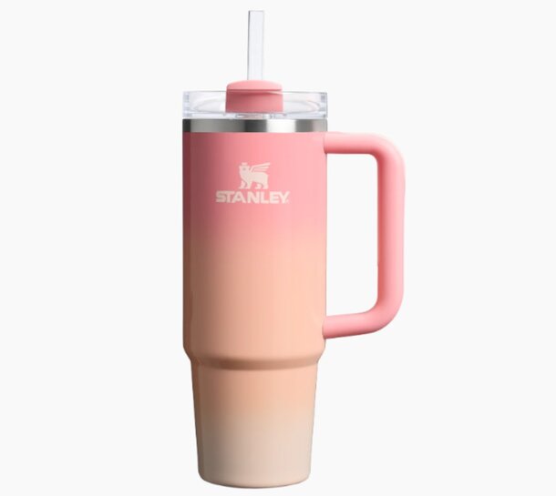 A pink Stanley tumbler with a straw, designed for easy sipping and stylish hydration on the go.