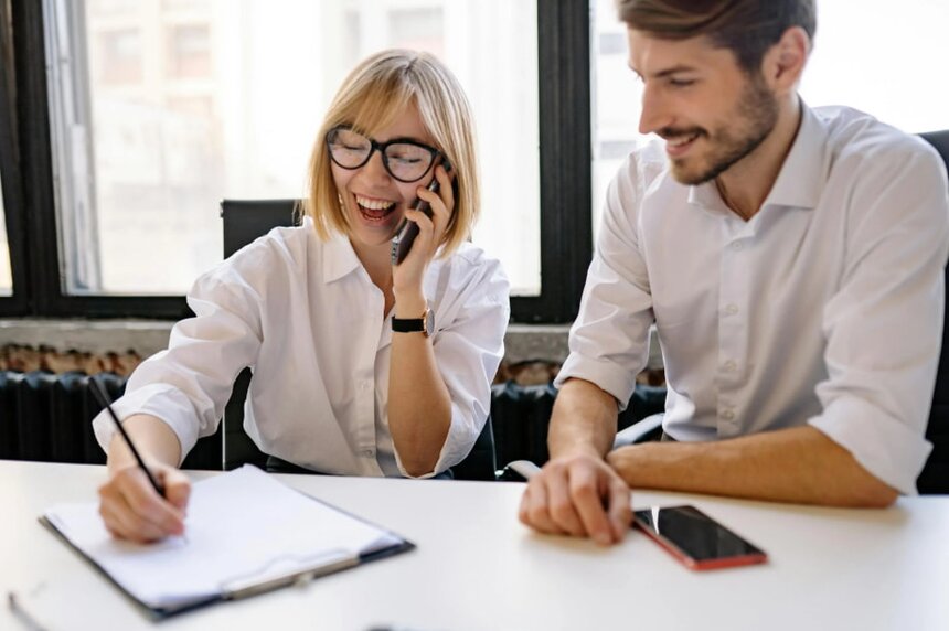 A woman smiles and gives a thumbs up, expressing positivity and approval.  