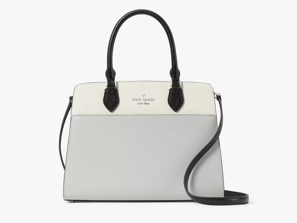 Elegant Kate Spade handbag in a chic white and black color scheme.