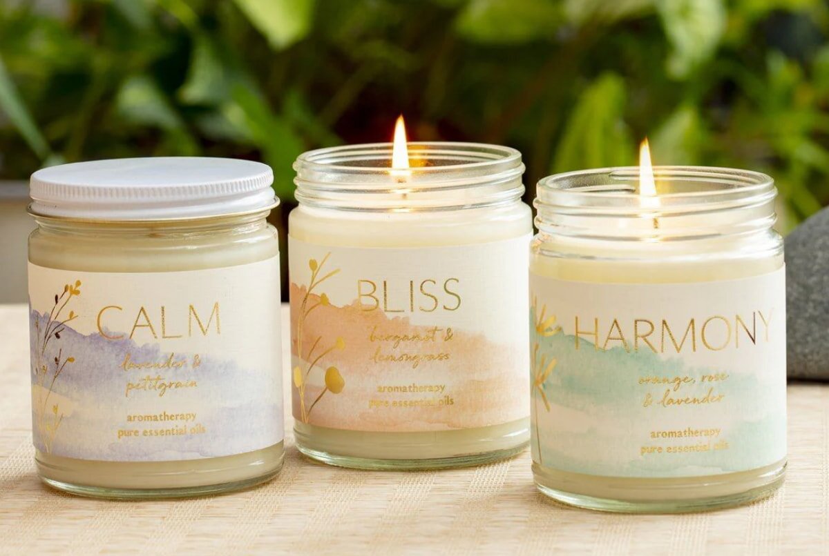 Three candles labeled "calm," "harmony," and "peace" arranged together, symbolizing tranquility and balance.