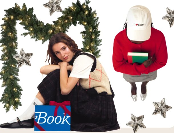 A woman in a red sweater and skirt sits on a chair, reading a book with a focused expression.