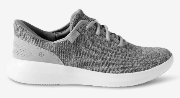 Women's gray and white sneaker with a modern design, featuring a comfortable sole and stylish accents.