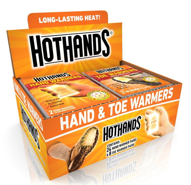 Brightly colored retail display box for HotHands Hand & Toe Warmers. The packaging highlights "Long-Lasting Heat!" with images of hands and feet.