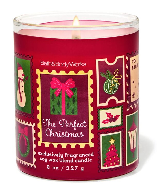 A festive Bath & Body Works candle labeled "The Perfect Christmas" with holiday-themed packaging and a warm glow.
