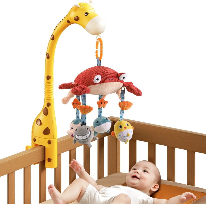 Baby in crib with colorful toy mobile