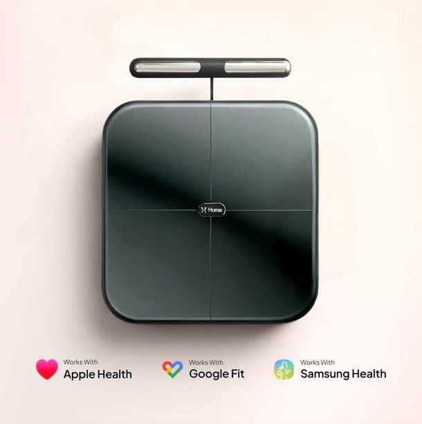A sleek, black digital scale with a handle, branded "Hume," on a light background. It supports Apple Health, Google Fit, and Samsung Health apps.