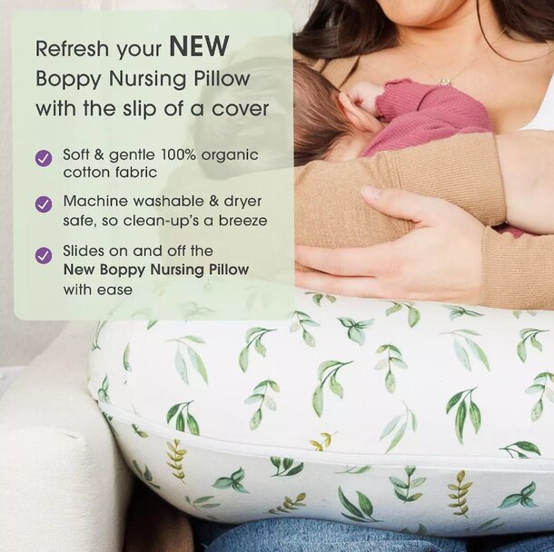 A woman cradles her baby in a nursing pillow, providing support during breastfeeding.