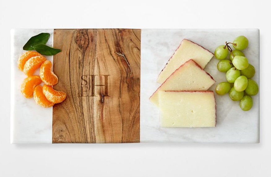 Monogrammed cutting board with cheese, grapes, and fruit