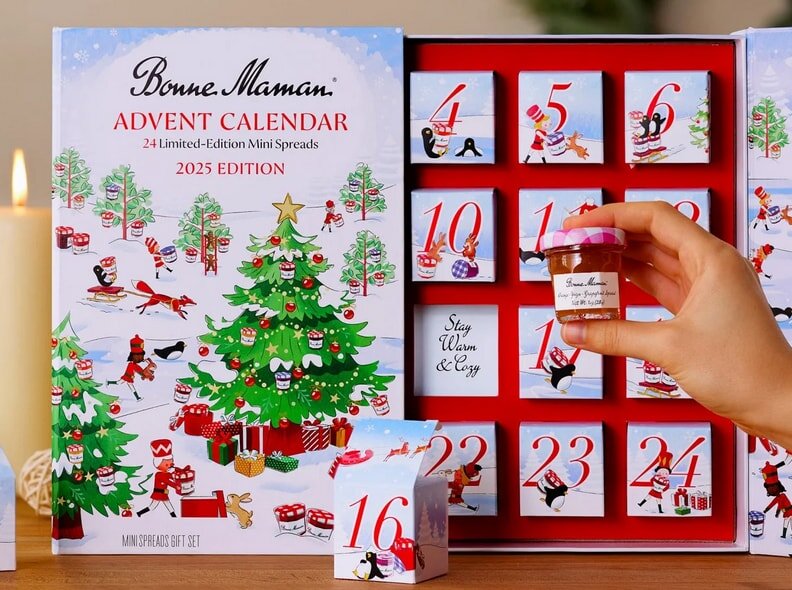 Bonne Maman advent calendar with 24 mini spreads. A hand holds a jar, revealing festive numbered boxes.