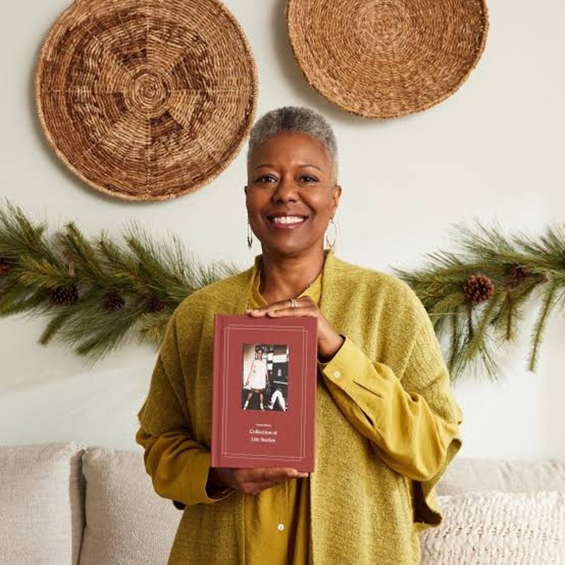 Hardcover Storyworth memoir book with a personalized cover, opened to pages of family stories.