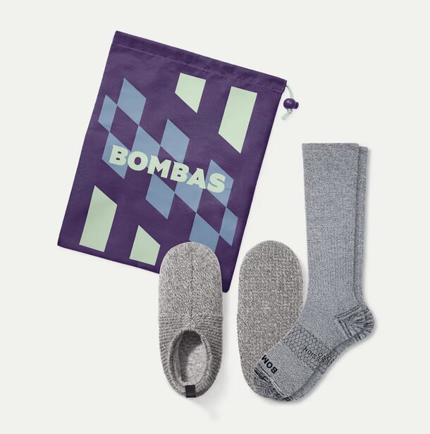 Bombas socks displayed alongside a purple bag, showcasing a stylish and colorful accessory combination.  