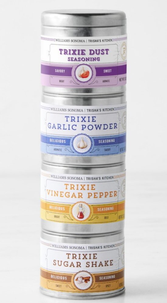 Three tins containing various spices and herbs, showcasing a colorful assortment for culinary use.