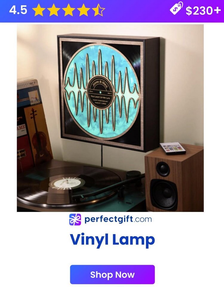 Vinyl lamp with glowing blue design on wall, turntable, and speaker nearby. PerfectGift.com ad with 4.5 stars, $230+.