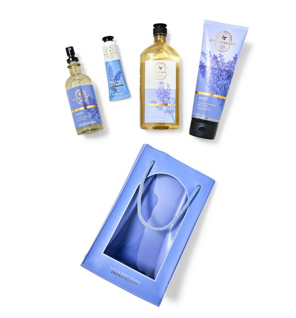 Lavender body care set featuring lotion, scrub, and bath oil in elegant packaging.