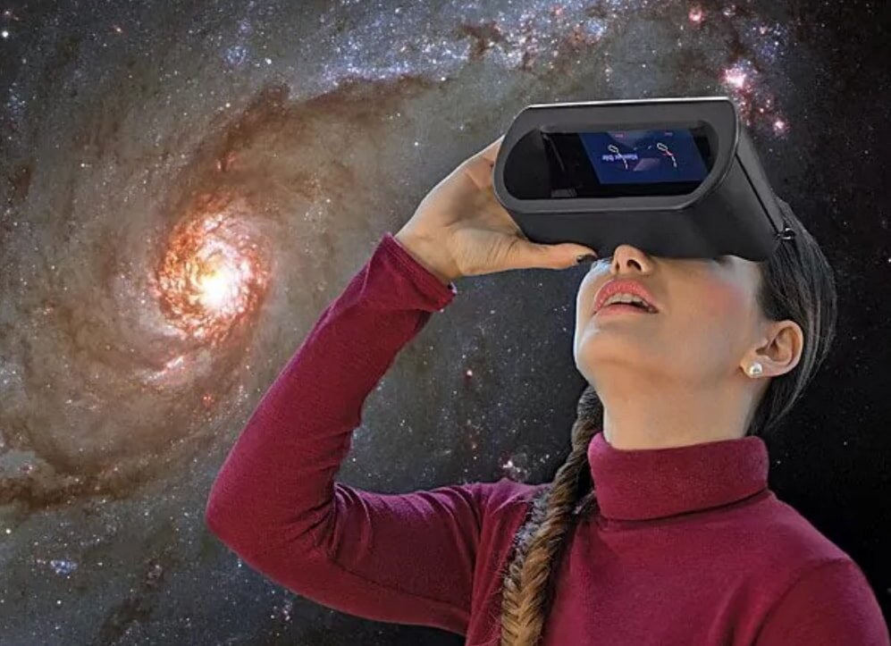 A woman with a virtual reality headset explores a vibrant galaxy, surrounded by stars and swirling cosmic elements.