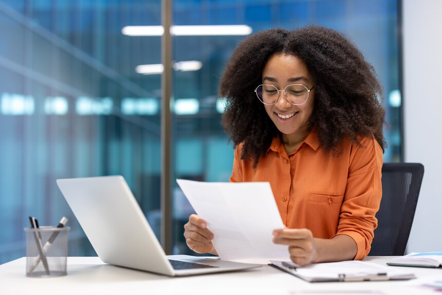 A woman shakes hands with a customer in a restaurant, showcasing a friendly and professional interaction.  