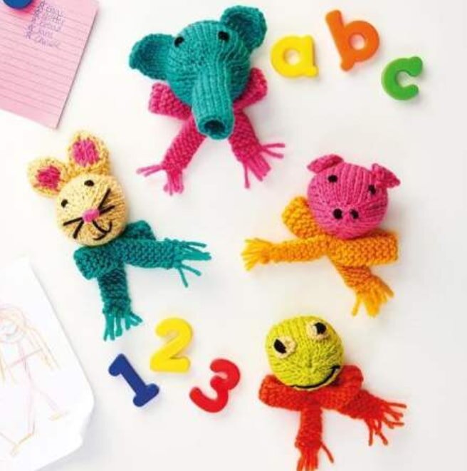 Four colorful knit animal heads with scarves and plastic letters "a," "b," "c" and numbers "1," "2," "3" on a white background. Playful and cheerful.