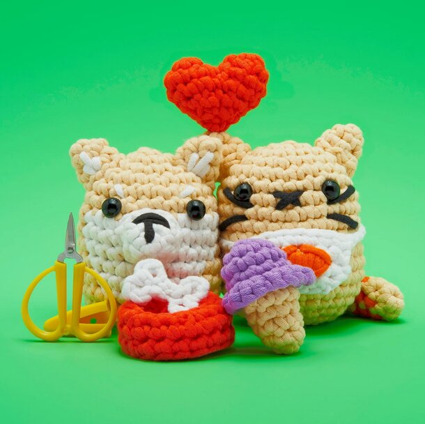 Amigurumi crochet corgi sitting beside a colorful ice cream cone, showcasing playful and whimsical craftsmanship.