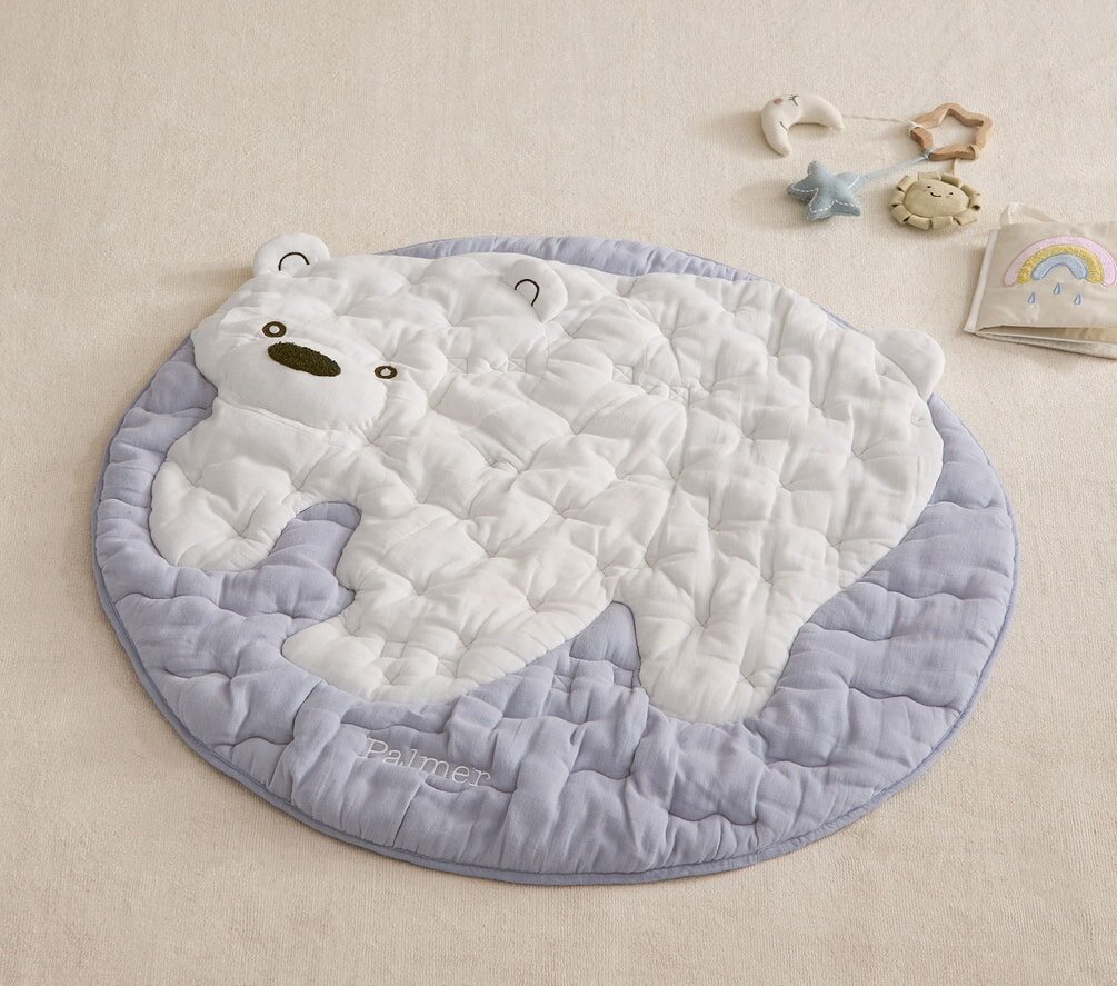 A baby bear playing mat featuring a cute blue and white bear design, perfect for infants to play and explore.