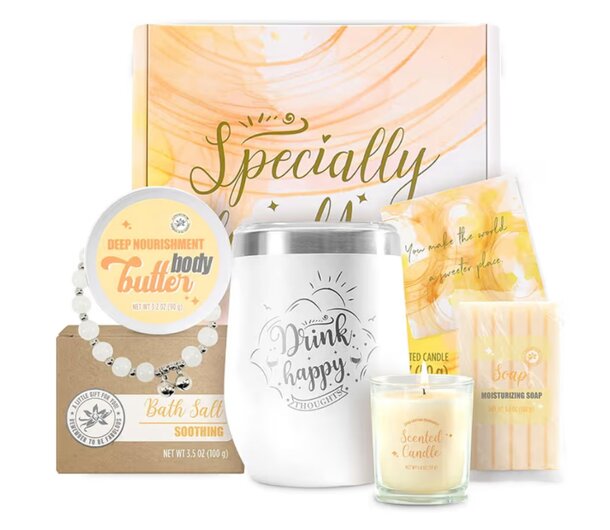 A gift box containing a mug and several candles arranged neatly inside.