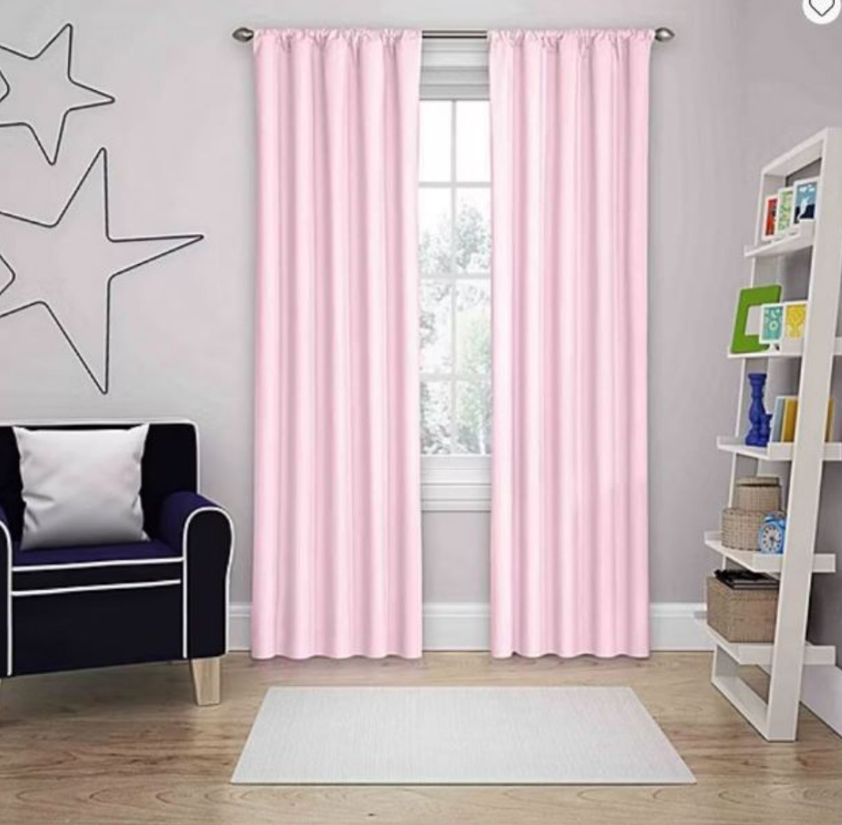 A pink curtain hangs in a room with a chair and a window, creating a cozy atmosphere.