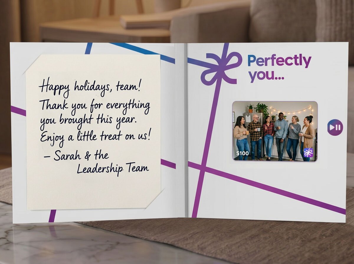 Open PerfectGift greeting card with a handwritten happy holidays note to the team and a gift card showing a candid photo of smiling coworkers